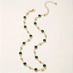 Annalena – Collana di smeraldi con dettagli in oro.