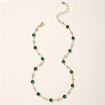 Annalena – Collana di smeraldi con dettagli in oro.