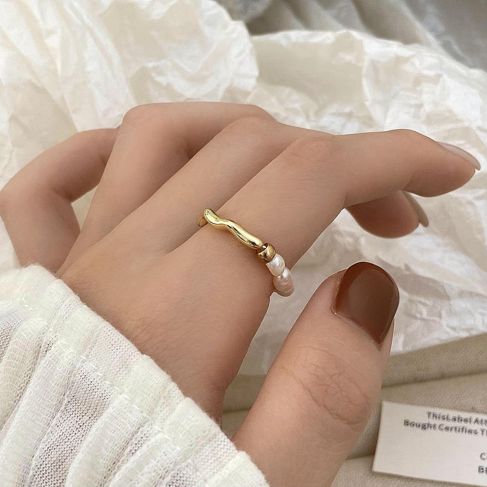 Elisa - Un anello di perle giocoso con un cuore dorato.