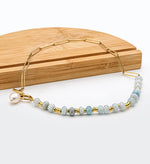 Zoé – Lunghi orecchini in oro con pendente di perla.