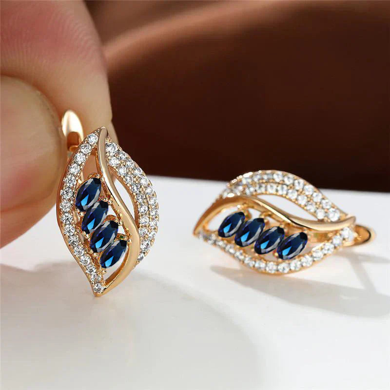 Nora – Orecchini in oro con zaffiro e zircone.