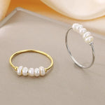 Rosalie – Anelli pendenti in oro con perla.