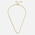 Frieda – Collana dorata con pendente curvo