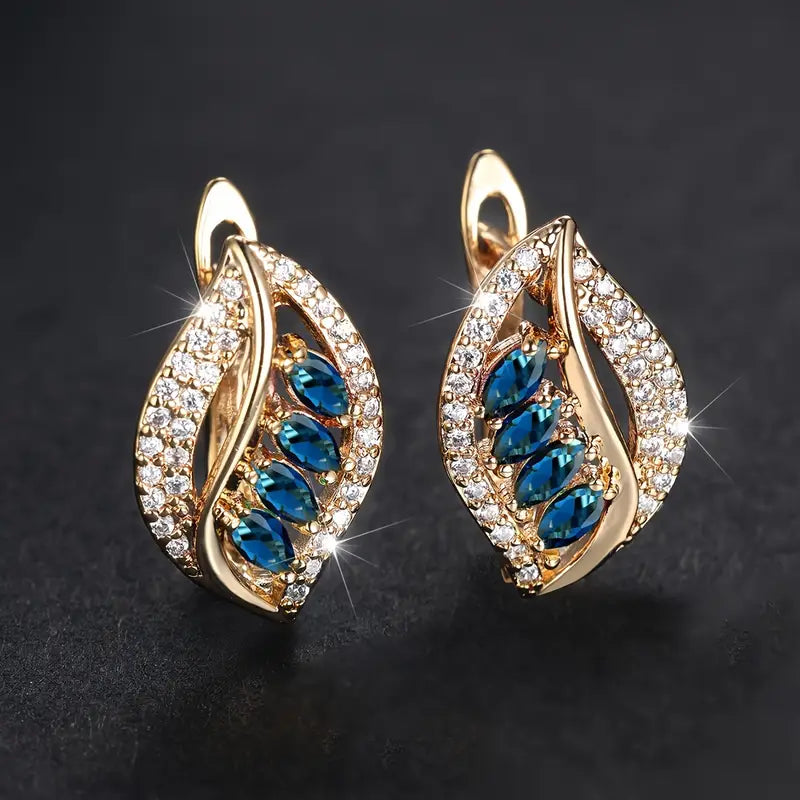 Nora – Orecchini in oro con zaffiro e zircone.