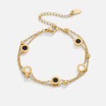 Carla – Delicato bracciale in oro con elementi rotondi a contrasto.